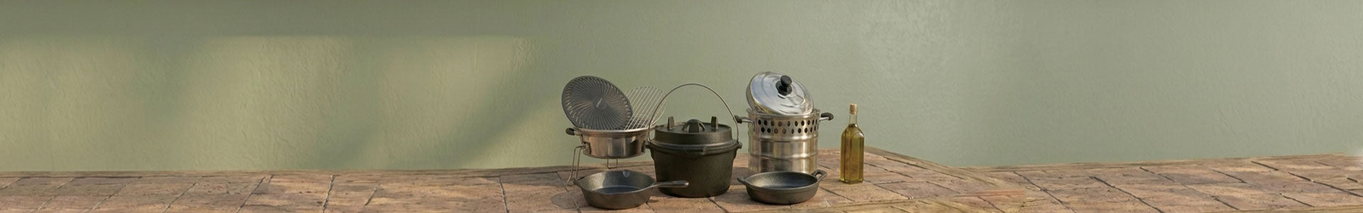 An assortment of SSM stove accessories, including cast iron cookware, pots, grates, and a glass bottle, arranged neatly on a stone-tile surface against a neutral background.