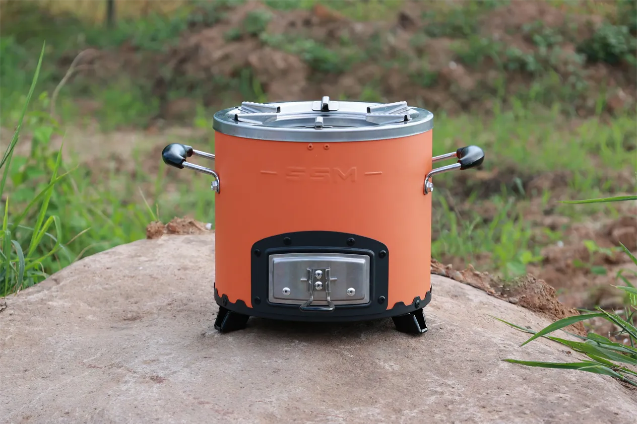 An orange SSM charcoal stove placed on a modern kitchen countertop, surrounded by elegant cookware.