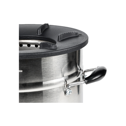 Close-up view of the cast-iron cooktop and secondary air ventilation system on the C28-23MAX charcoal stove, highlighting the high-efficiency design engineered for the fastest cooking performance.