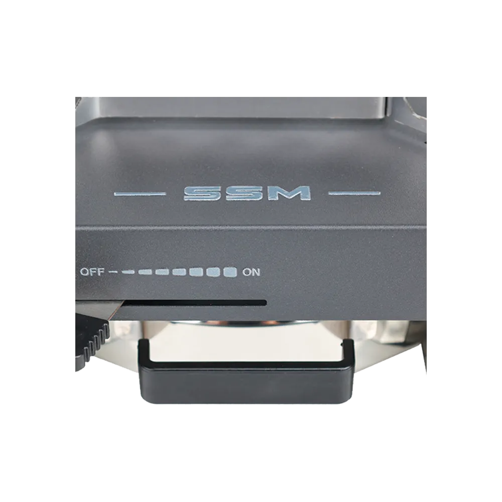 Close-up view of the SSM brand logo and precision OFF-to-ON fuel regulation control panel on the ethanol stove.