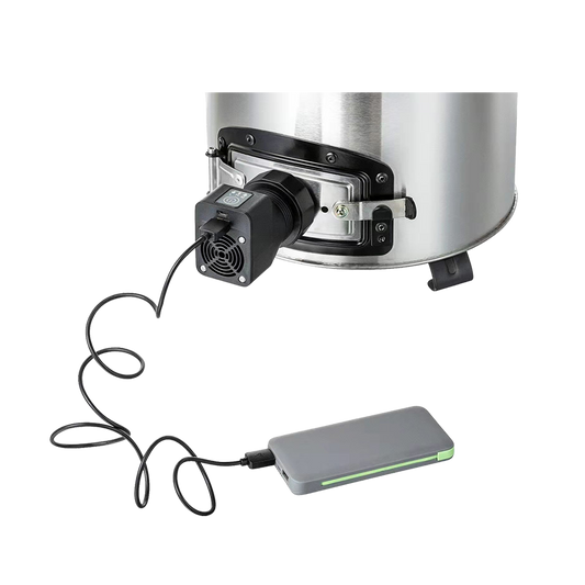 Close-up of the F-18 fan stove’s airflow module connected to a portable power bank for mobile operation.