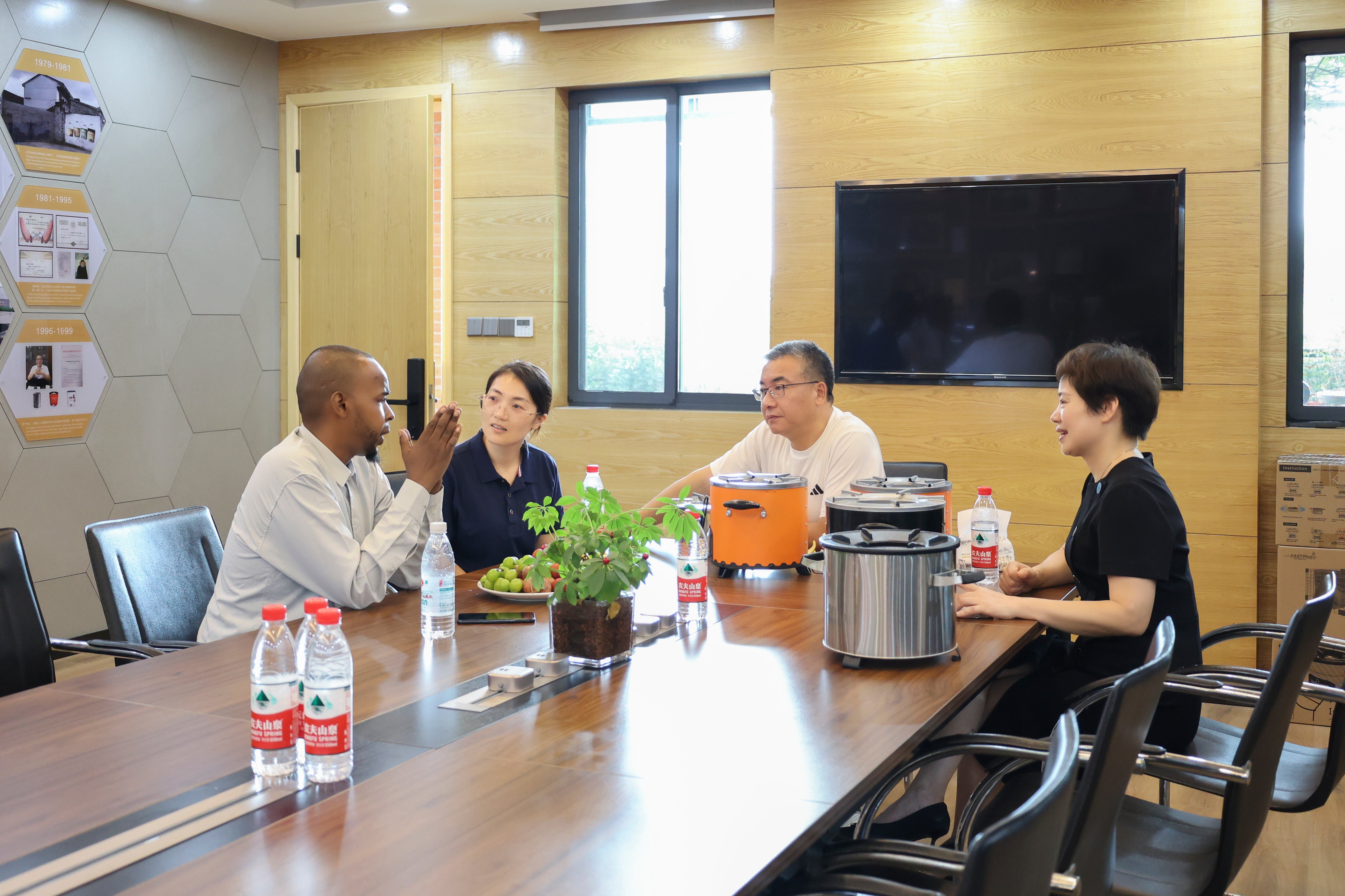 Photos of our team introducing our stoves to customers in the conference room and discussing their needs.